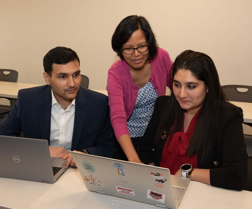 A professor helping a student in a classroom