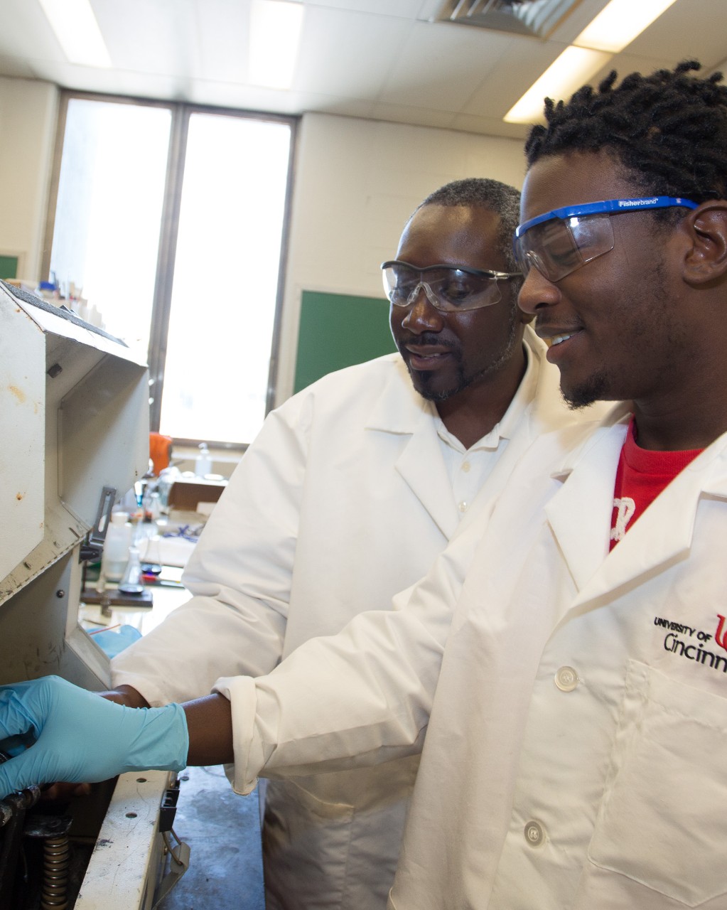 LabChemistry Prof James Mack with REU student Kingsley Benson working in lab.
