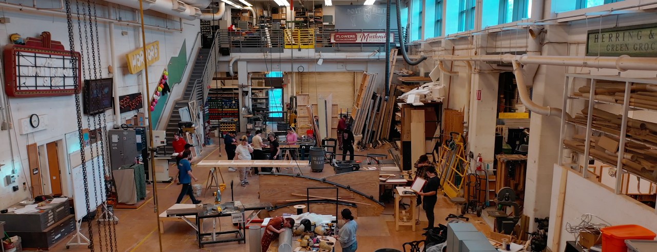 A photo of students and faculty working in CCM's Scene Shop.