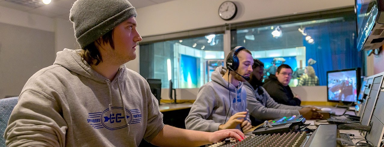 Four Media Production students work the control panel in the Bartlett Television Control Room