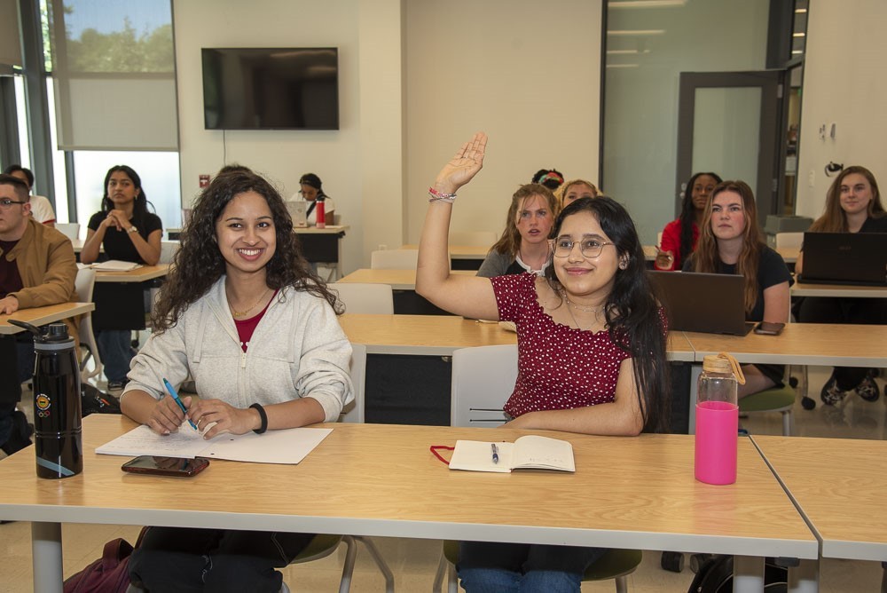 room of several students sitting at classrooms at UC Blue Ash