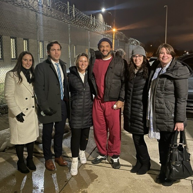 Six people standing outside a prison with OIP exoneree Richard Horton