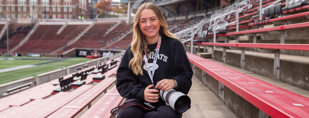Maylea Salmon poses with her camera at Nippert Stadium.