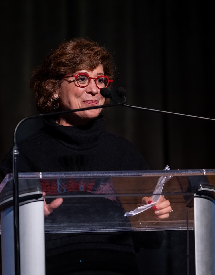 Roseann Hassey speaks from the event podium
