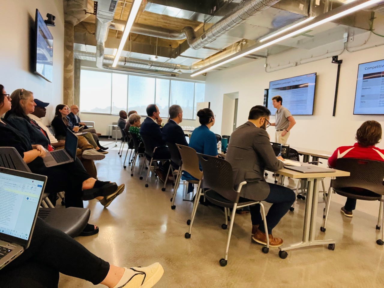 A man stands in front of a classroom of people.