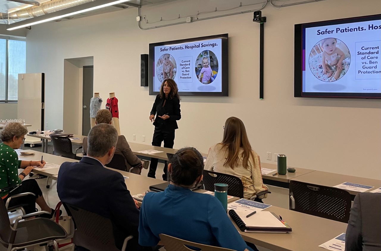 A woman talks to a classroom of people.