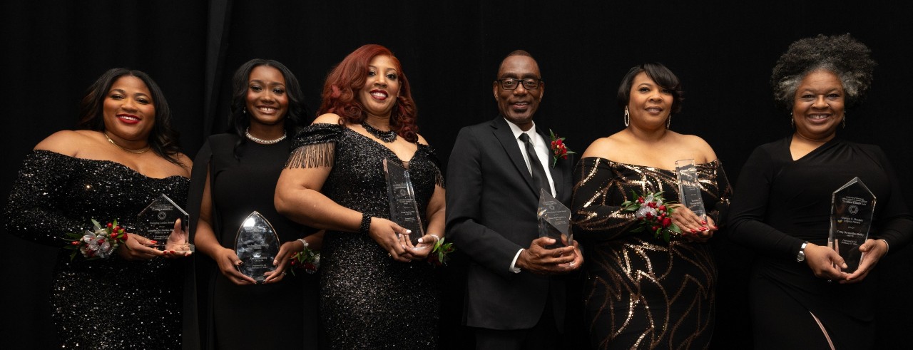 2024 Onyx and Ruby Gala honorees stand and smile holding their awards