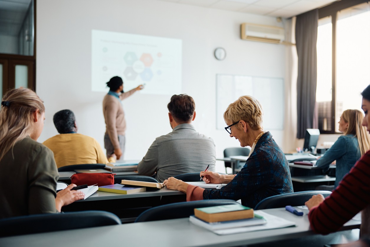 Students and teacher in college classroom