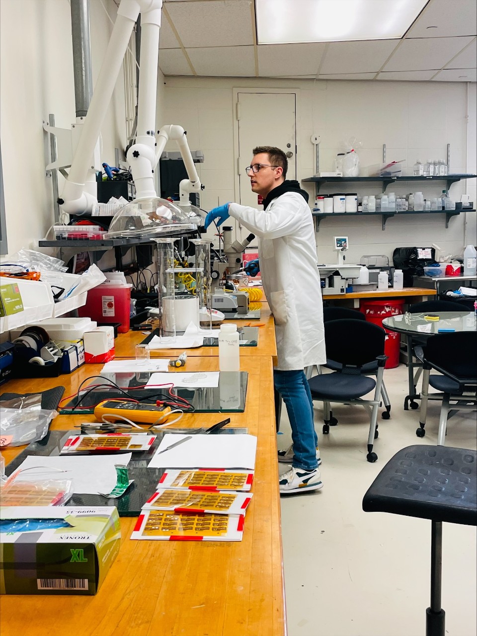 Inside Jason Heikenfeld's laboratory, a UC student tests the chips to be inserted inside the wearable device.