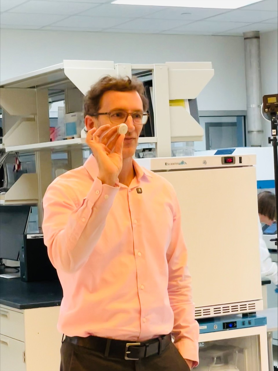Jason Heikenfeld holds up a prototype of his device.