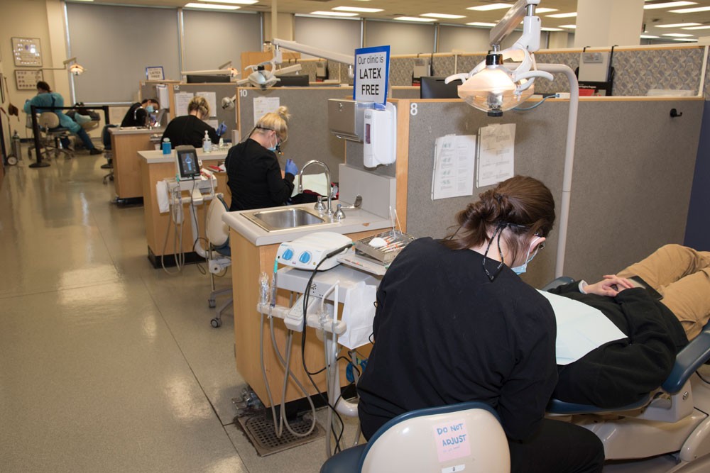 dental hygiene clinic with staff and patients