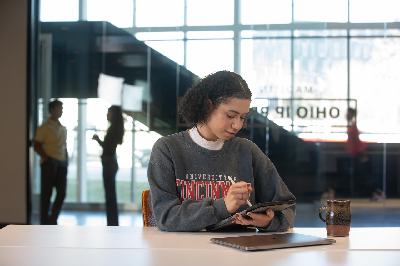 Student working on a tablet at UC's 1819 Innovation Hub. Photo/Andrew Higley