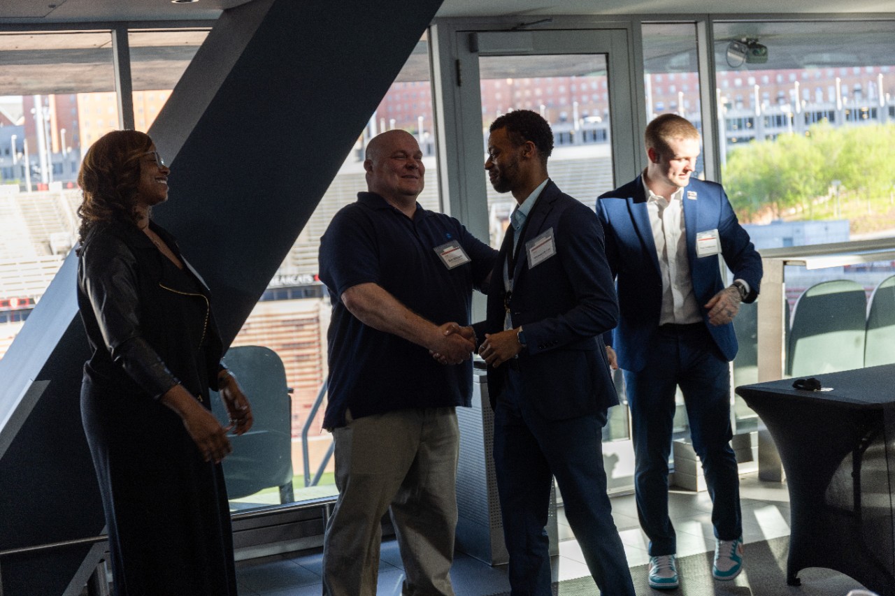 Michael Hunter shakes the hands of CEAS PDCI staff after receiving his award. 