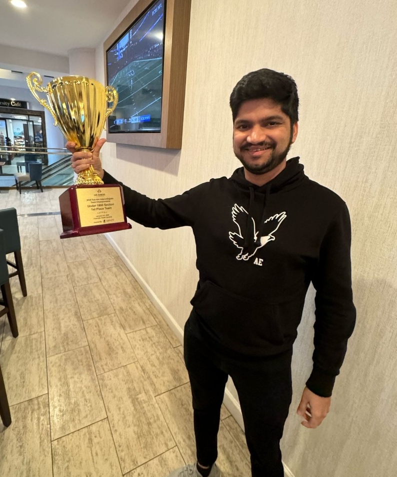 Gajanan Jayade holds up the championship trophy.