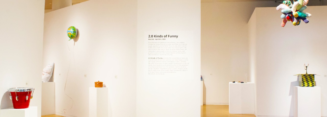 long view of the Reed Gallery showing 2.0 Kinds of Funny. Ballons and buckets and stuffed animals.