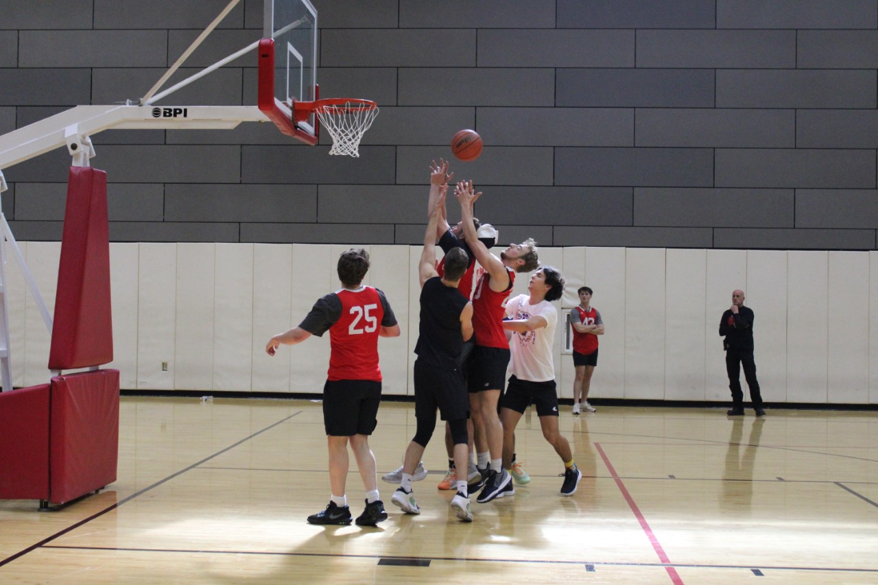 A player attempts to make a basket during a game at the UCPD 3v3 Scholarship Basketball Tournament