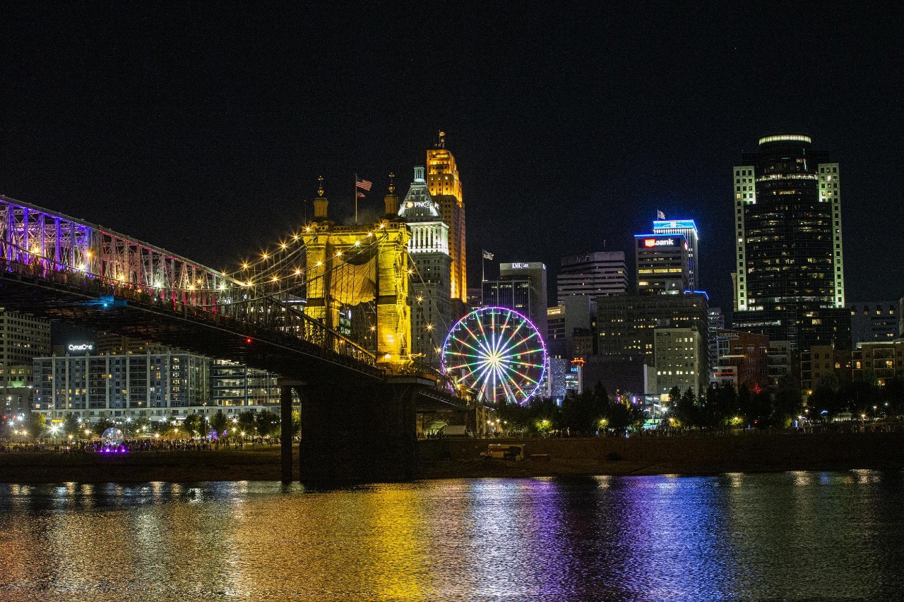 The Cincinnati skyline and Ohio River are illuminated by the colorful lights of the BLINK festival.