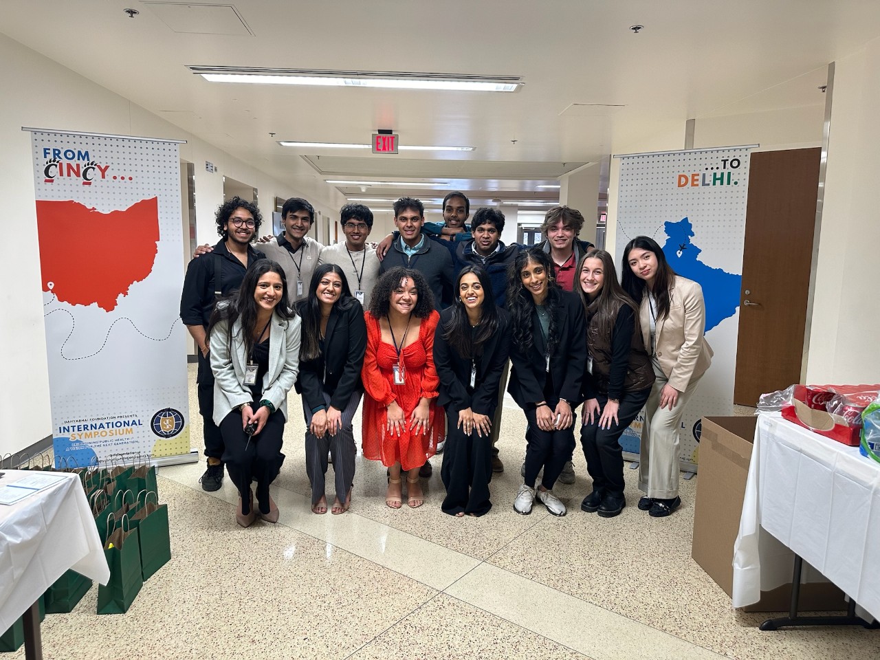 Students stand in a hallway in between two banners reading "From Cincy...to Delhi"