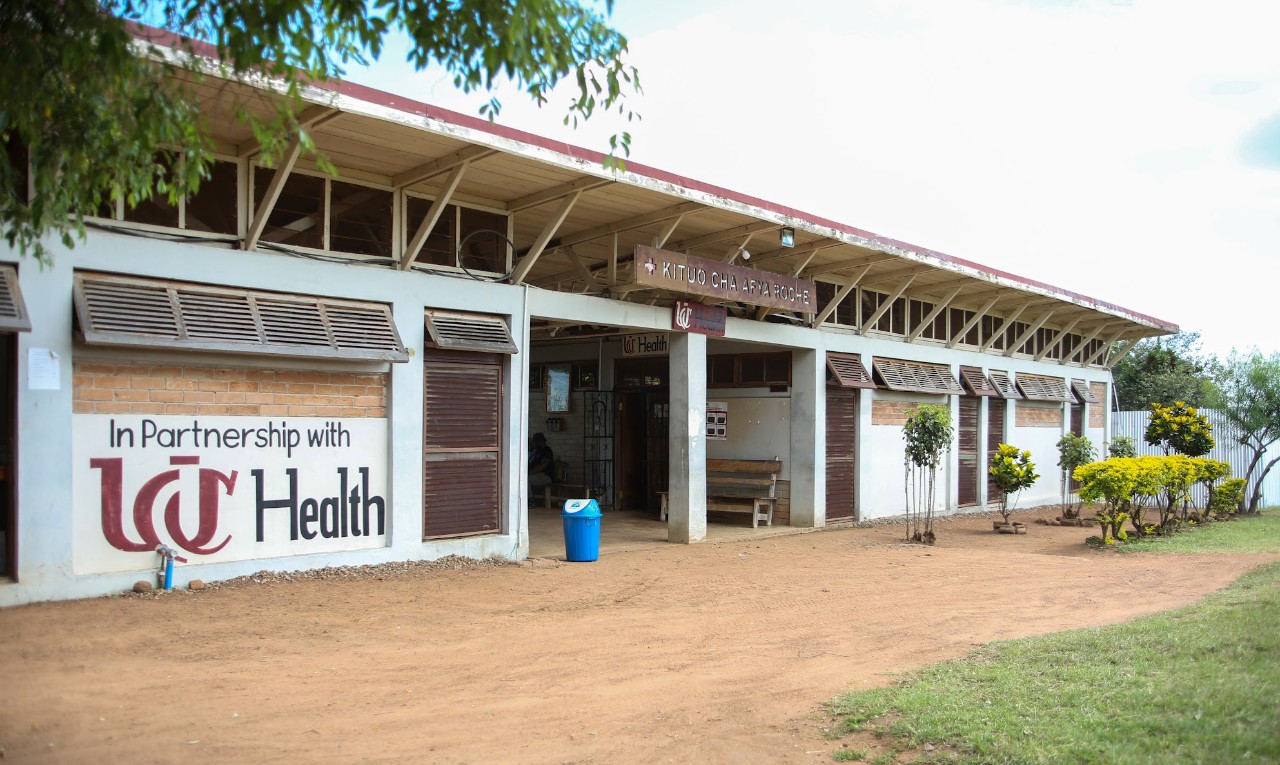 Front view of the Roche Health Center building with a sign painted on side stating, "In partnership with UC Health."