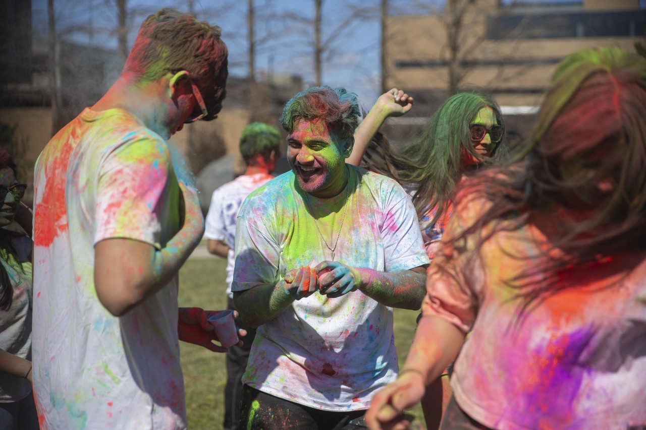 Students celebrate Holi festival of colors.