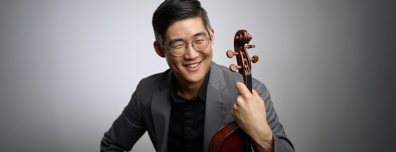 A portrait of Brian Hong with his viola. 