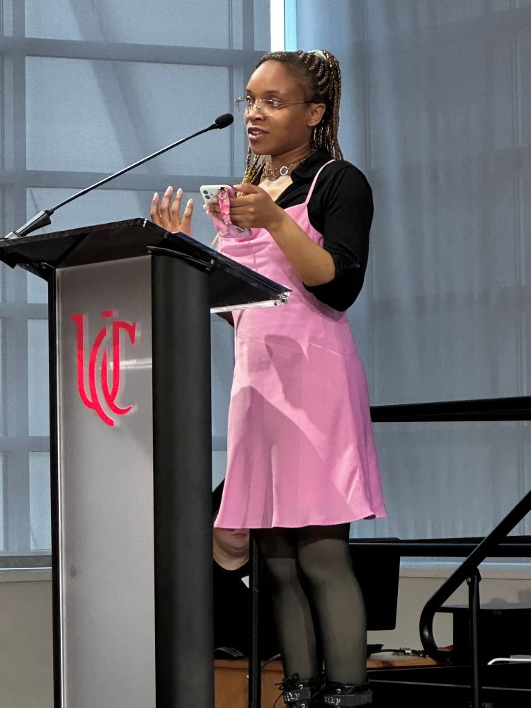 young woman speaks at a podium
