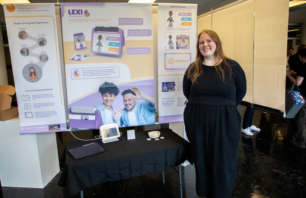 Kolis standing in front of her project