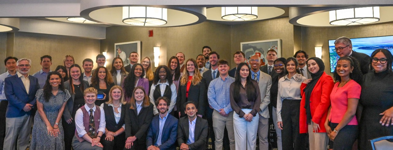 Lindner's MBA graduates and faculty and staff pose in a group at the Montgomery Inn Boathouse