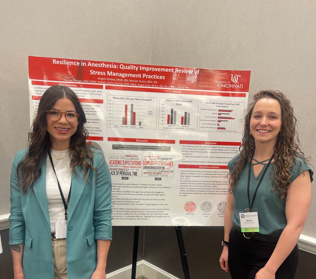 Angela Dobos and Mariah Dutro stand beside their research poster on stress management, presented at the Ohio State Association of Nurse Anesthetists conference.