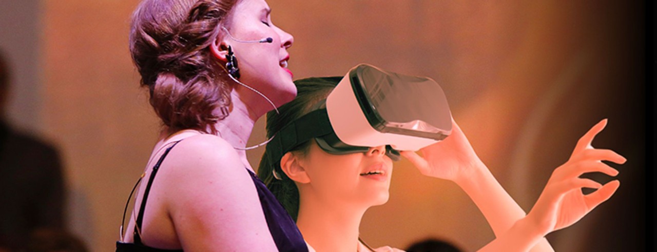 Erin Alcorn singing alongside a person in a VR headset