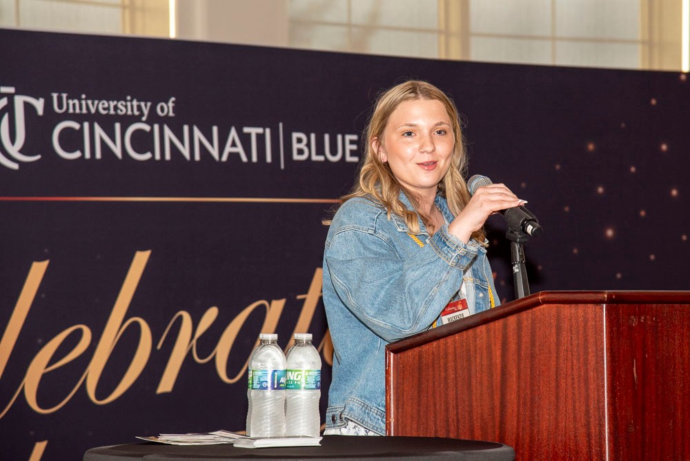 female student speaking at podium