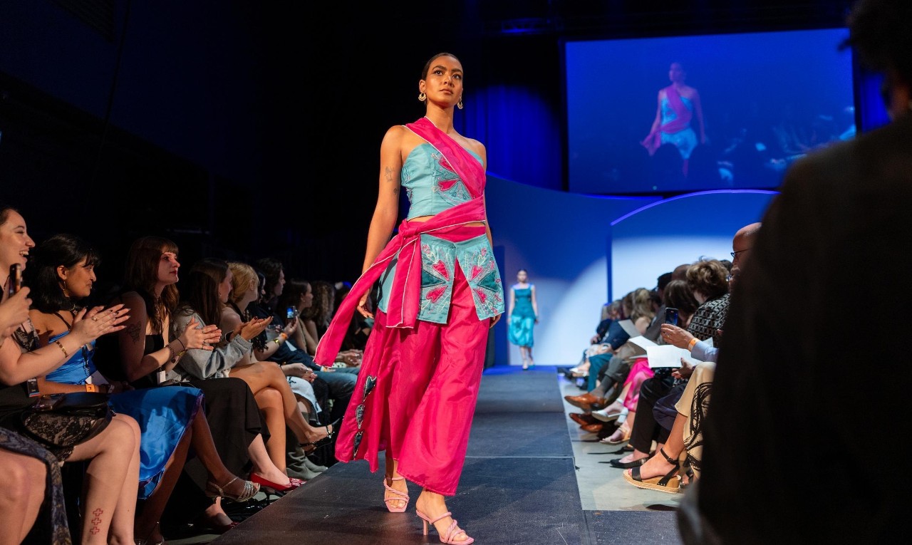 model on the runway in red and blue two piece set