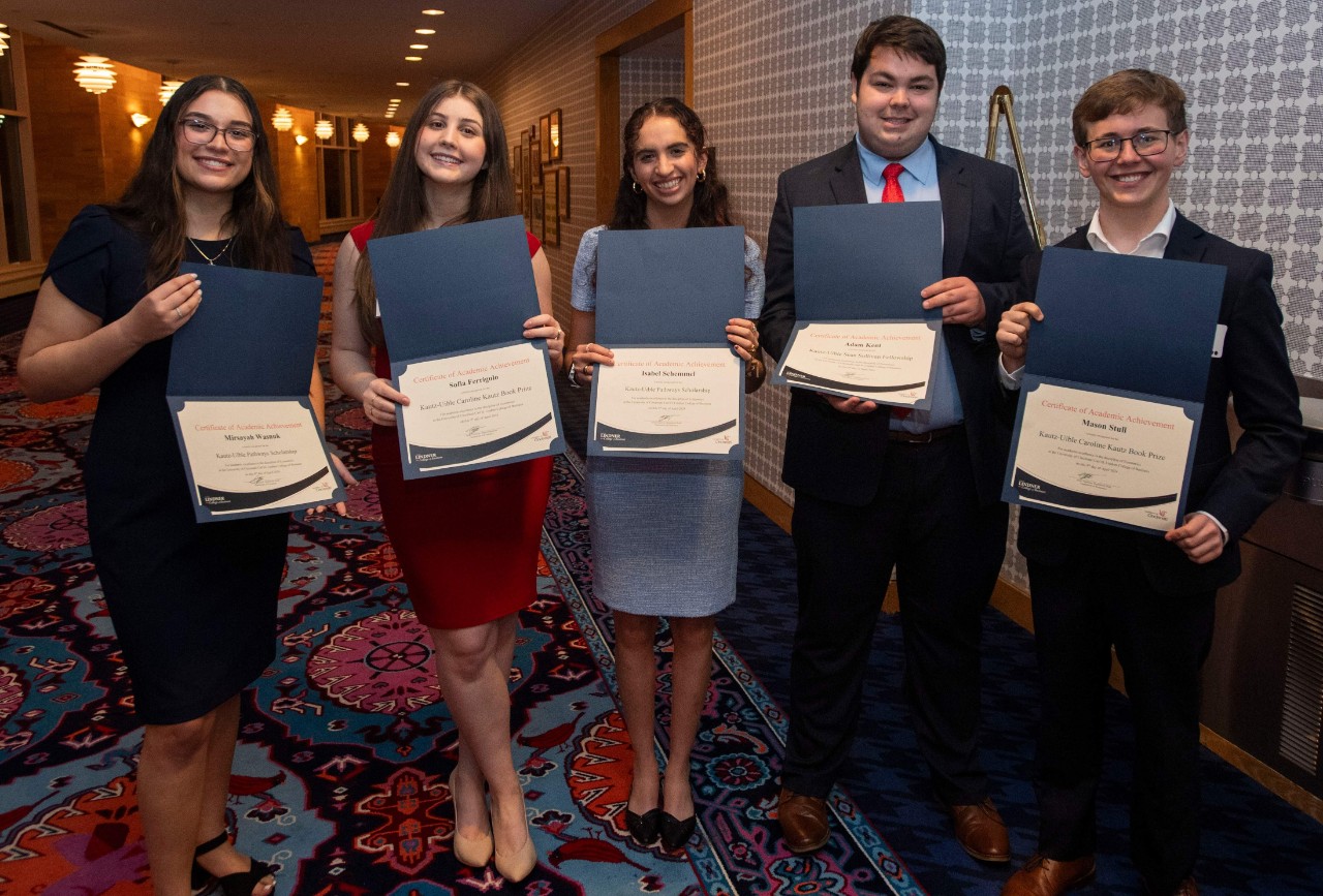 UC student stop for a photo with their merit scholarships