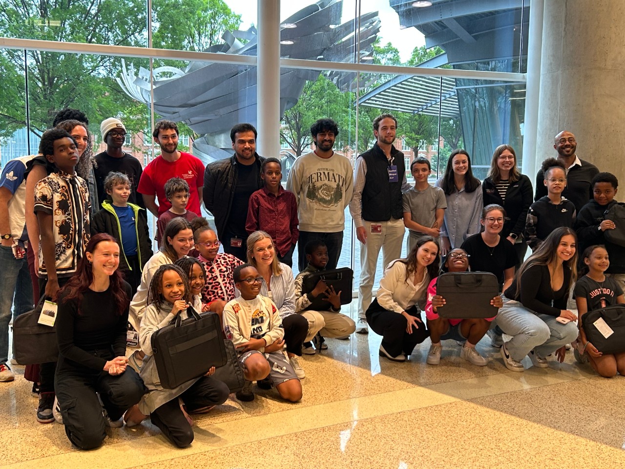 UC Med Mentors and students gathered for a group photo with their new laptops