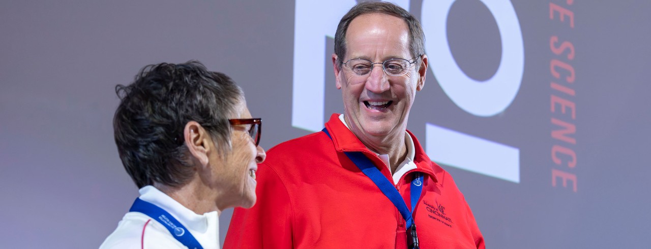 Bradley Wilson smiles at an event while standing next to a colleague