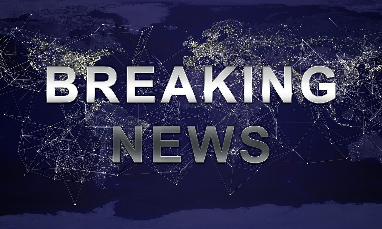 Image of broadcast news screen reading BREAKING NEWS in all caps.