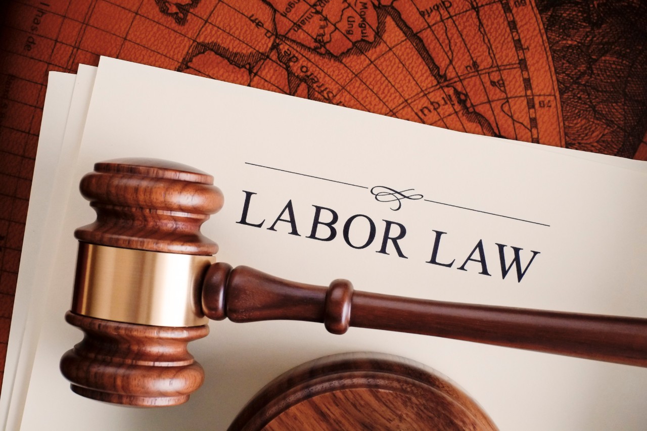 image of a stack of papers title Labor Law and a gavel lying on top