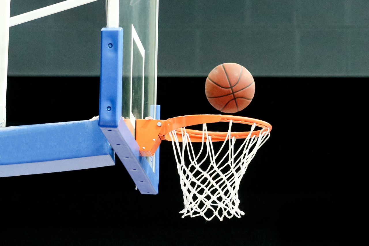 Basketball going through a hoop.