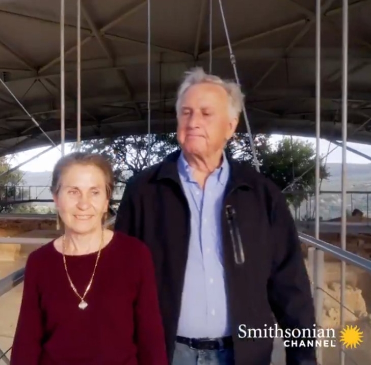 Jack Davis and Sharon Stocker stand on a scaffolding over an excavation.
