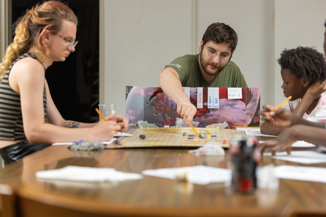 Honors students taking the Dungeons & Dragons summer seminar teach kids how to play at local libraries.