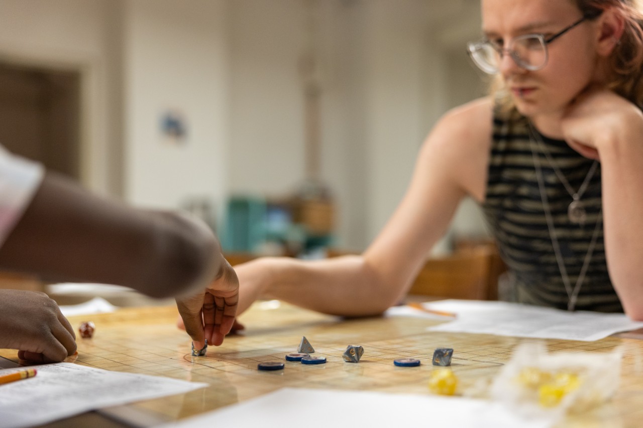 Honors students taking the Dungeons & Dragons summer seminar teach kids how to play at local libraries.