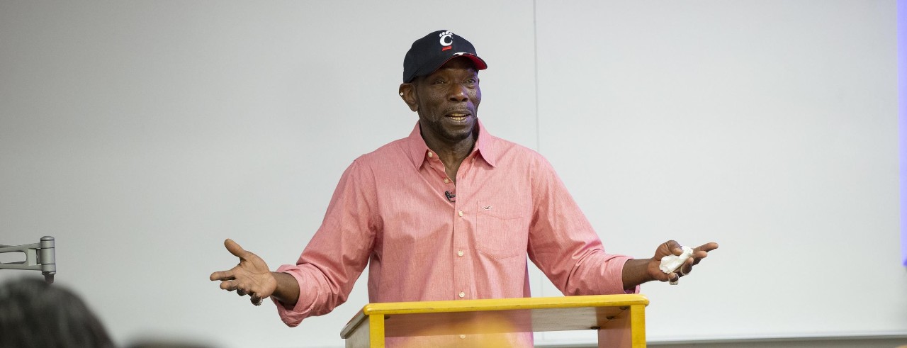 Image of Ricky Jackson standing at podium speaking and gesturing with his hands