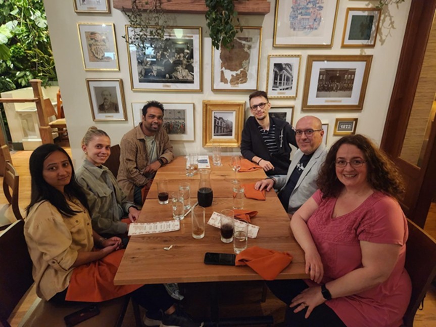 Members of the Drosatos Lab seated around a table.