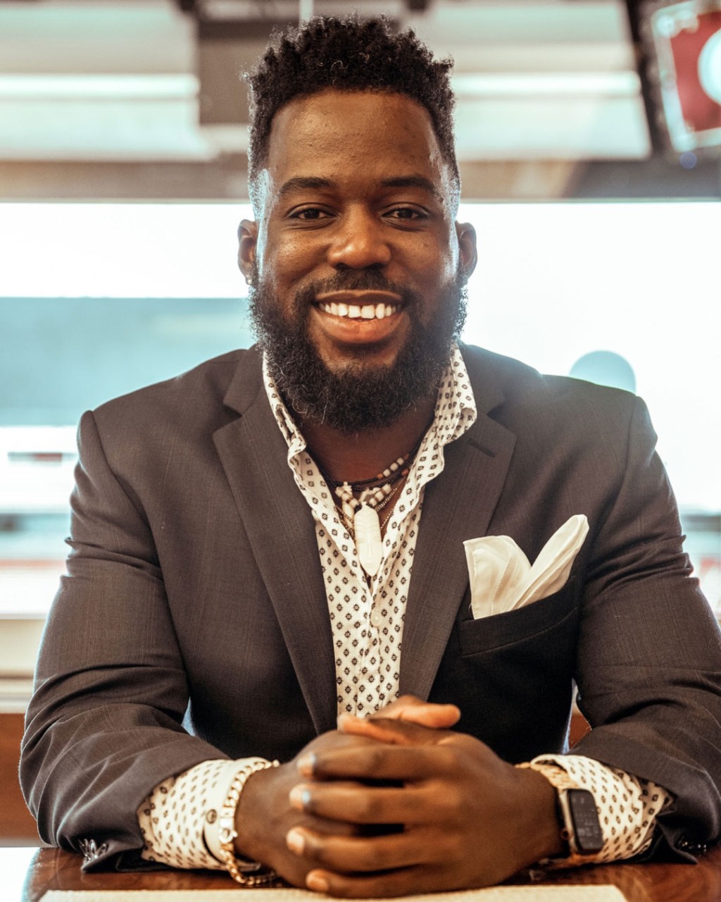 photo of A. Lamont Williams seated with clasped hands and smiling