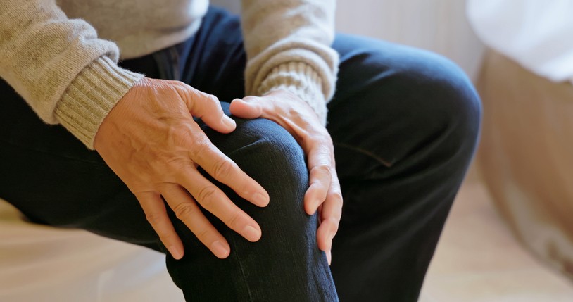 A person holding their knee in pain