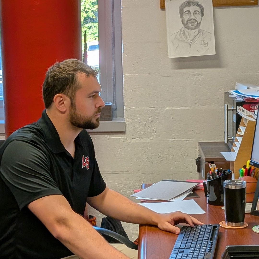 Zach Schmucker works at a computer in his office at La Salle High School.