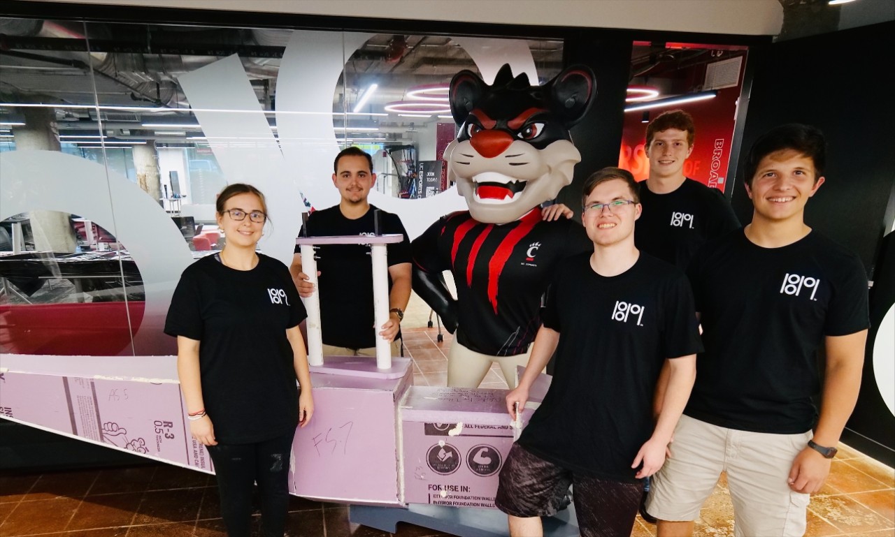 UC students stand beside the aircraft they built