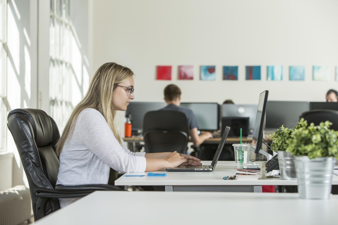A person sitting at a desk using a computer
