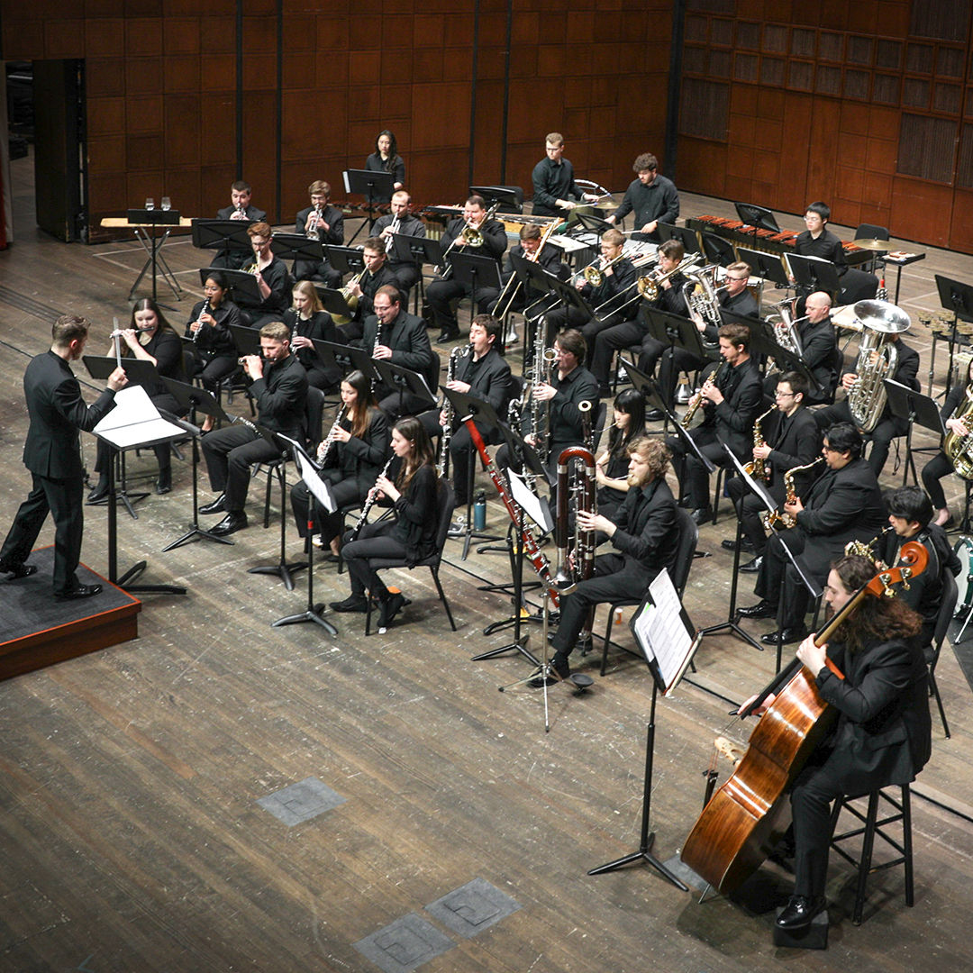 CCM Wind Symphony performs on stage.