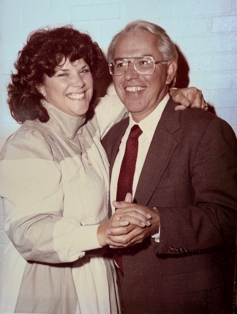 Carol and Joe Steger smiling and holding hands.